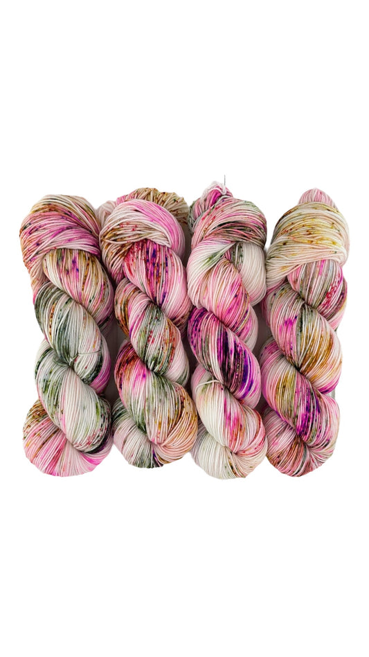 Fresh Start hand dyed yarn.   Made from a luxurious blend of merino and nylon, this delightful yarn boasts vibrant shades of pink, gold, and green.