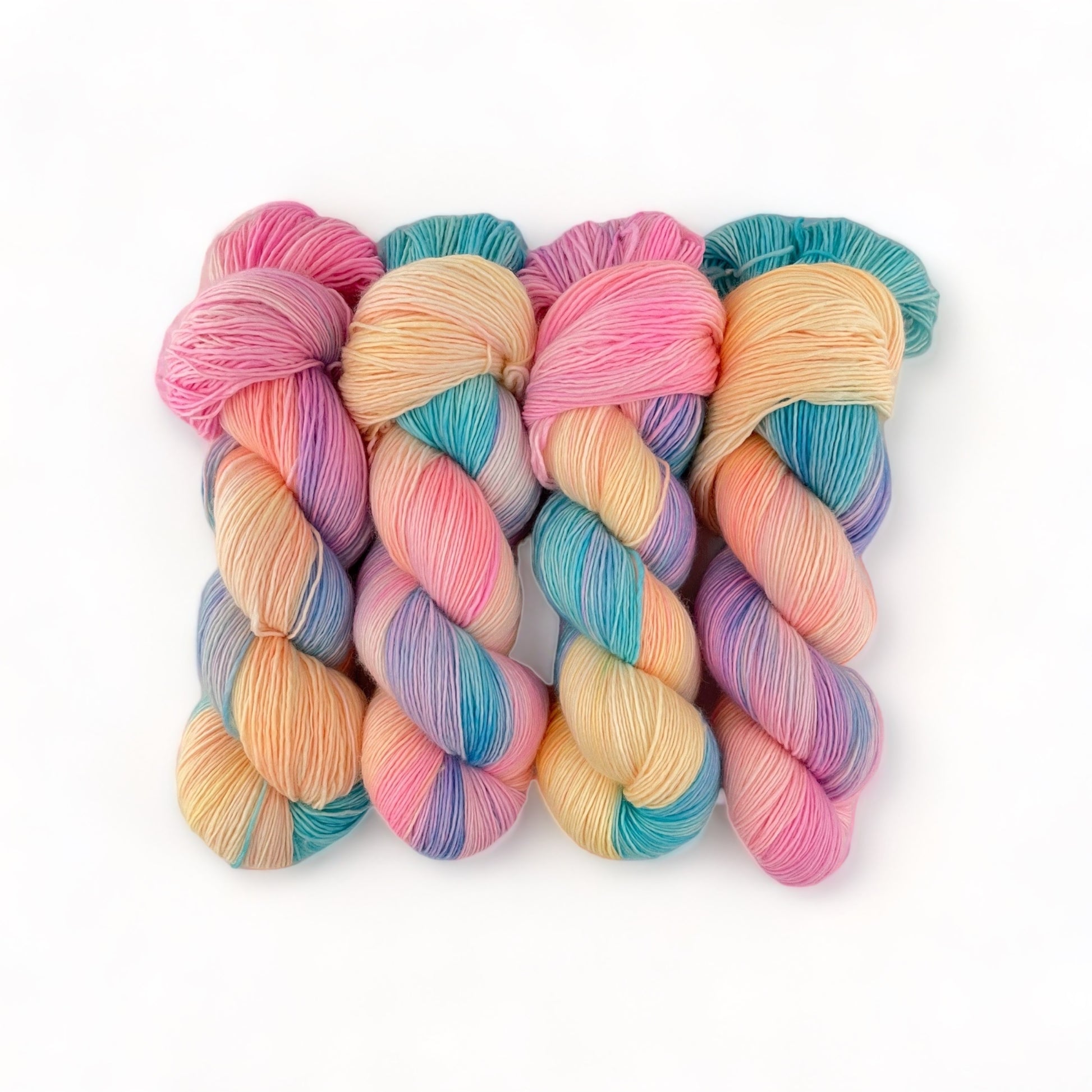 Hand Dyed Yarn! Made from 100% Extrafine Superwash Merino wool, this fingering/sock weight singles yarn boasts vibrant candy-colored hues. The result? Soft, durable, and one-of-a-kind creations that will make a statement. Indulge in the best of both worlds: luxury and fun.