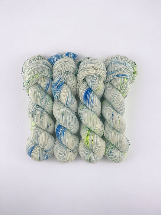 Made from a blend of Merino Wool and Nylon, this Fingering/Sock Weight Yarn is perfect for all your knitting & crochet projects. The pale blue base is elevated with splashes of green & blue, adding a unique touch to your designs.