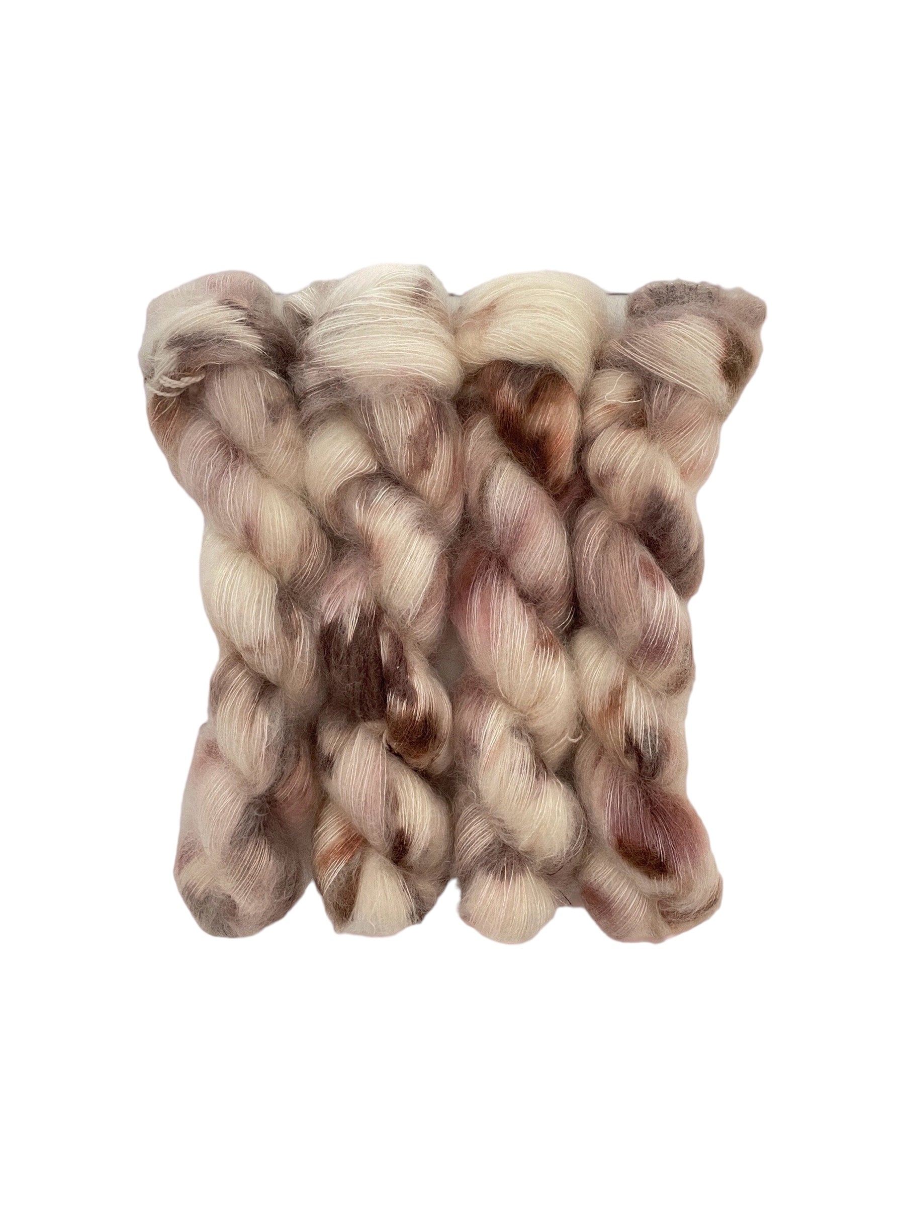 This luxurious COCONUT LATTE is handcrafted with a blend of hand dyed kid mohair and mulberry silk, resulting in a creamy texture with shades of brown and beige. The delicate materials provide a soft and gentle touch, while the rich colors add a touch of elegance.