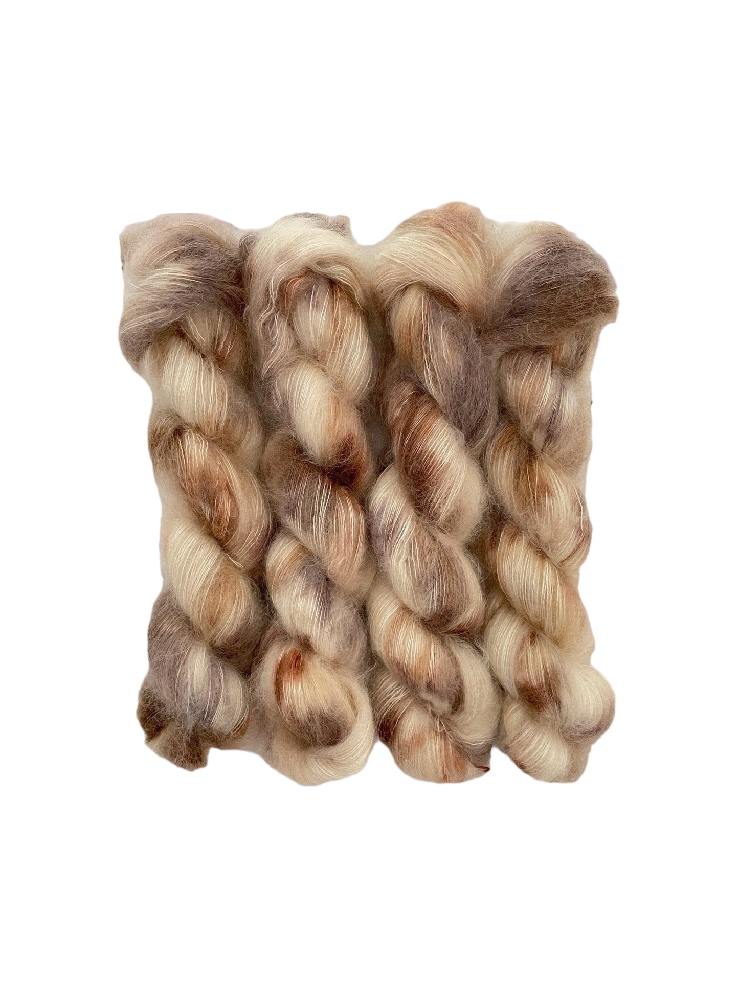 Experience the luxurious blend of kid mohair and silk with TATTERED TEDDY hand dyed yarn. The cream base is intricately dyed with beige & brown, creating a unique and stunning color combination. Perfect for delicate and lightweight lace projects.