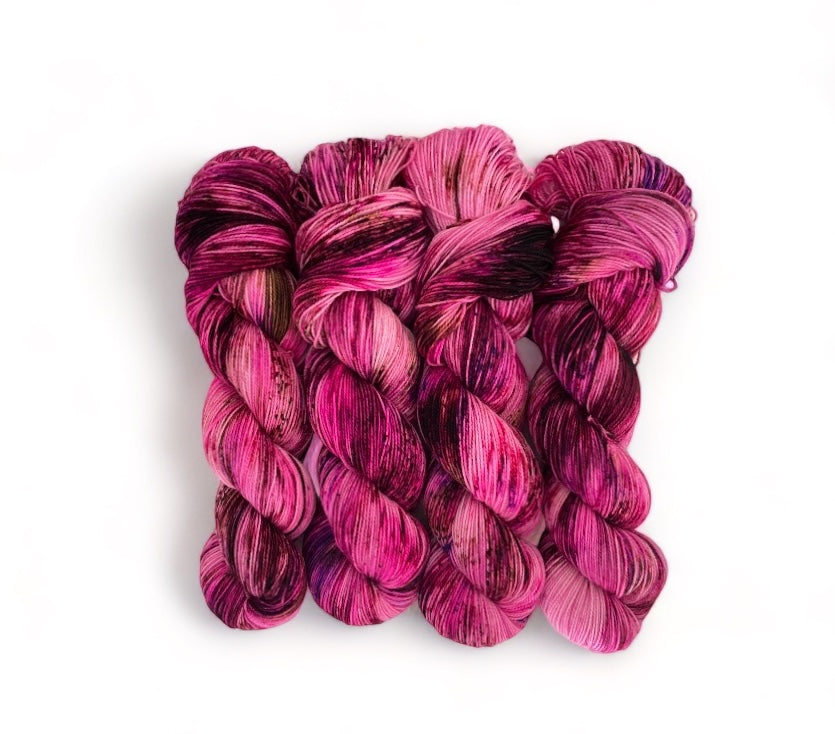 Expertly hand-dyed using premium British Blue Faced Leicester wool and nylon blend, HAPPY HEART yarn boasts a vibrant pink speckled design. This fingering/sock weight yarn is perfect for crafting durable and stylish accessories with a soft touch.