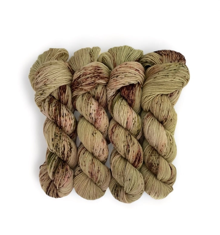 Expertly hand-dyed using premium British Blue Faced Leicester wool and nylon blend, HERB GARDEN yarn boasts a luxurious green and brown speckled design. This fingering/sock weight yarn is perfect for crafting durable and stylish accessories with a soft touch.