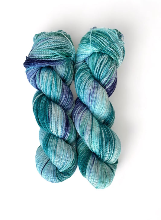 Made from soft merino, cashmere and mulberry silk fibers, this 100g skein boasts a lovely drape and is hand dyed in shades of blue.