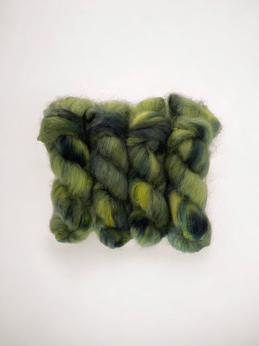 Elevate your knitting with our BEANSTALK Big Mohair yarn! Made with a luxurious blend of mohair, merino wool, and nylon, this hand-dyed yarn features  shades of greens. Perfect for double knit projects, each 100g skein adds a touch of warmth and texture to your creations.