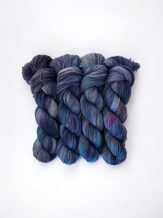 STARRY NIGHT yarn is made from 80% Superwash British Blue Faced Leicester wool for a soft, luxurious feel. The addition of 20% nylon adds durability and strength, making it perfect for socks and other projects. Available in a 100g skein in a beautiful palette of blues with a  dash of pink.